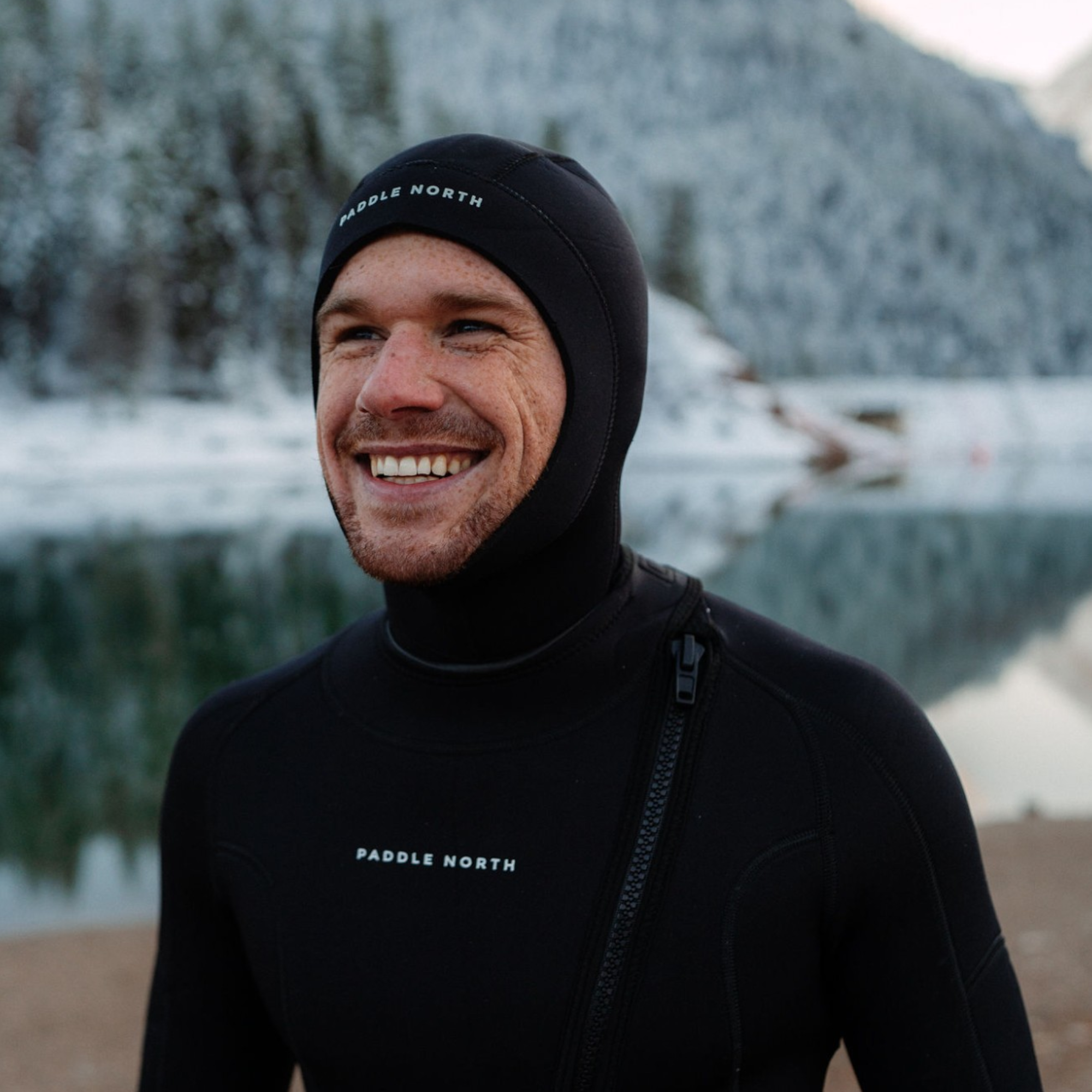 Man smiling wearing wetsuit in winter