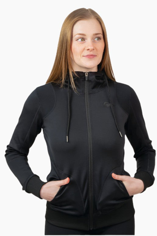 Woman wearing a black zip up hooded sweatshirt with her hands in her pocket.