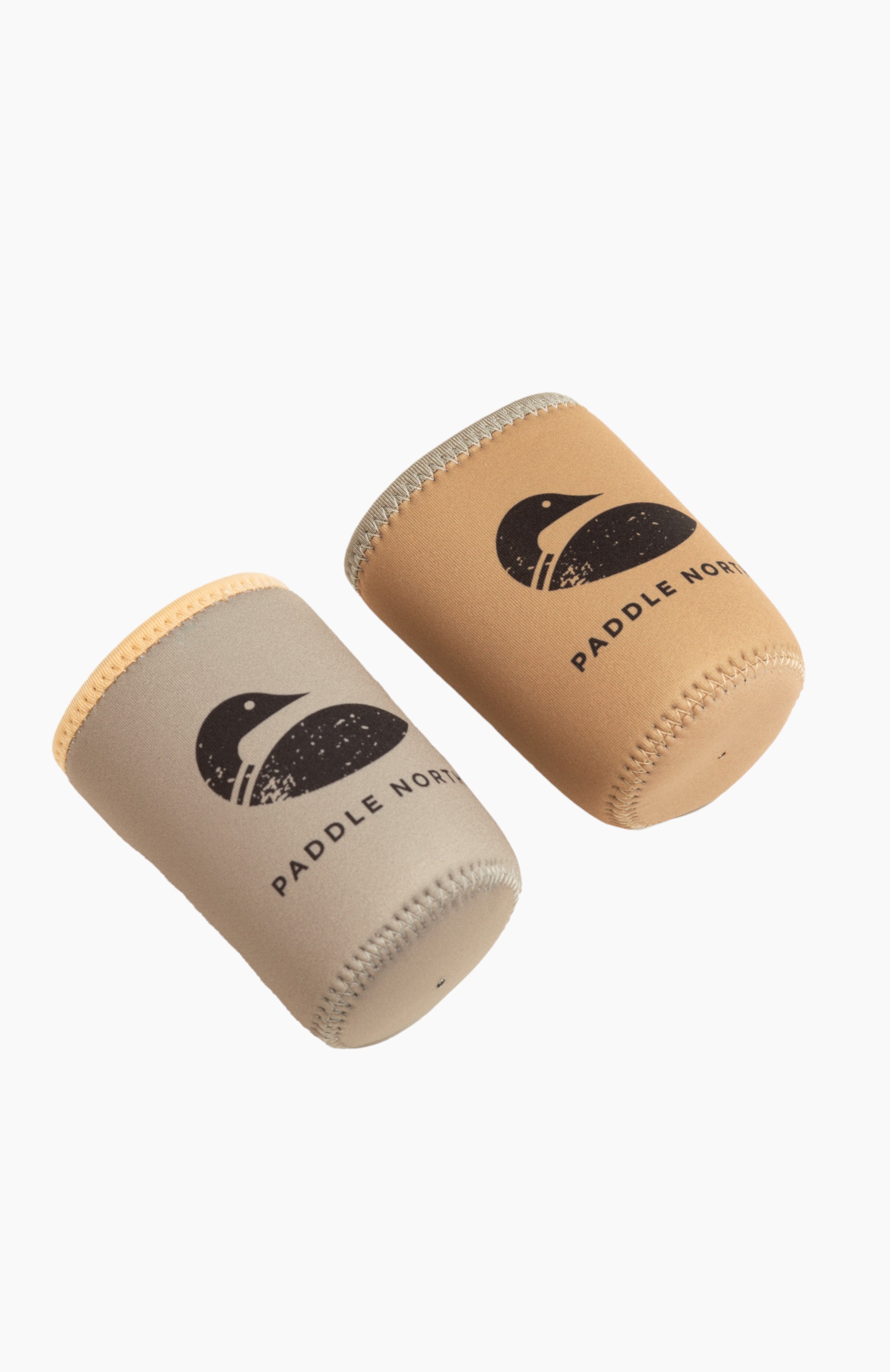 A grey and tan can koozie side be side with the paddle north logo.