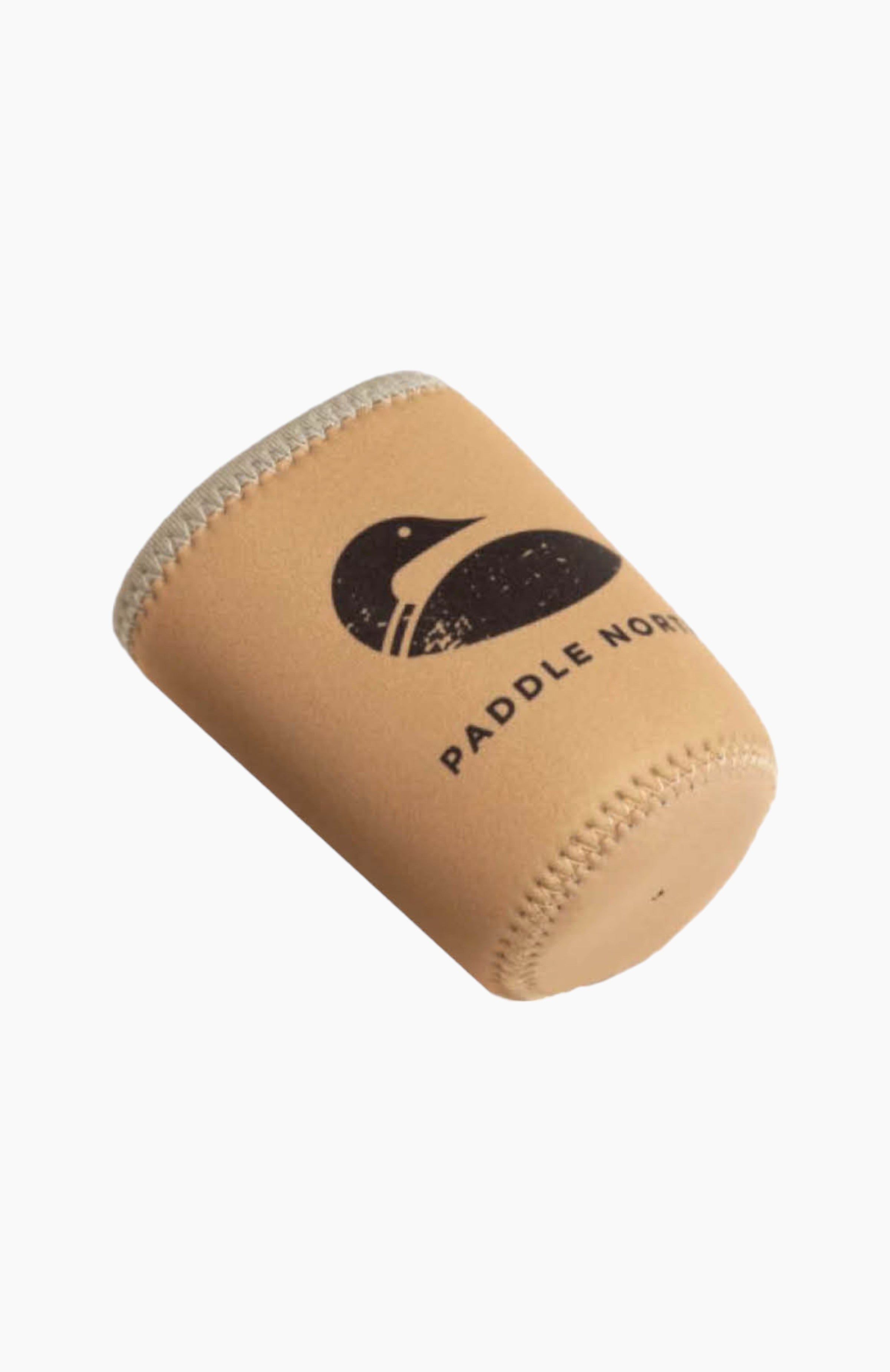 A tan can koozie with grey seam with the paddle north logo printed on one side.