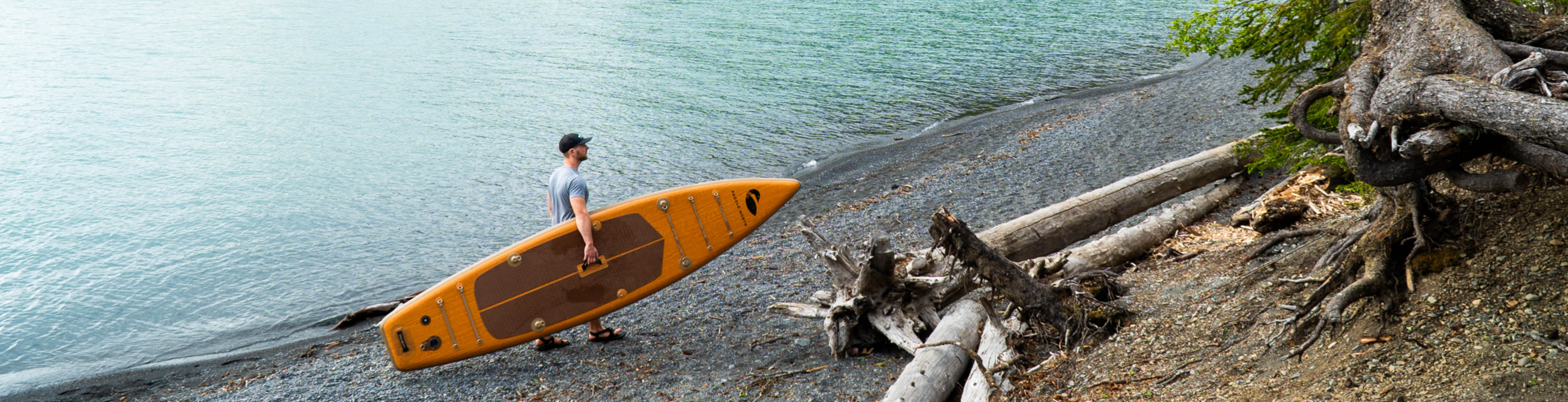 man carrying an inflatable paddle board