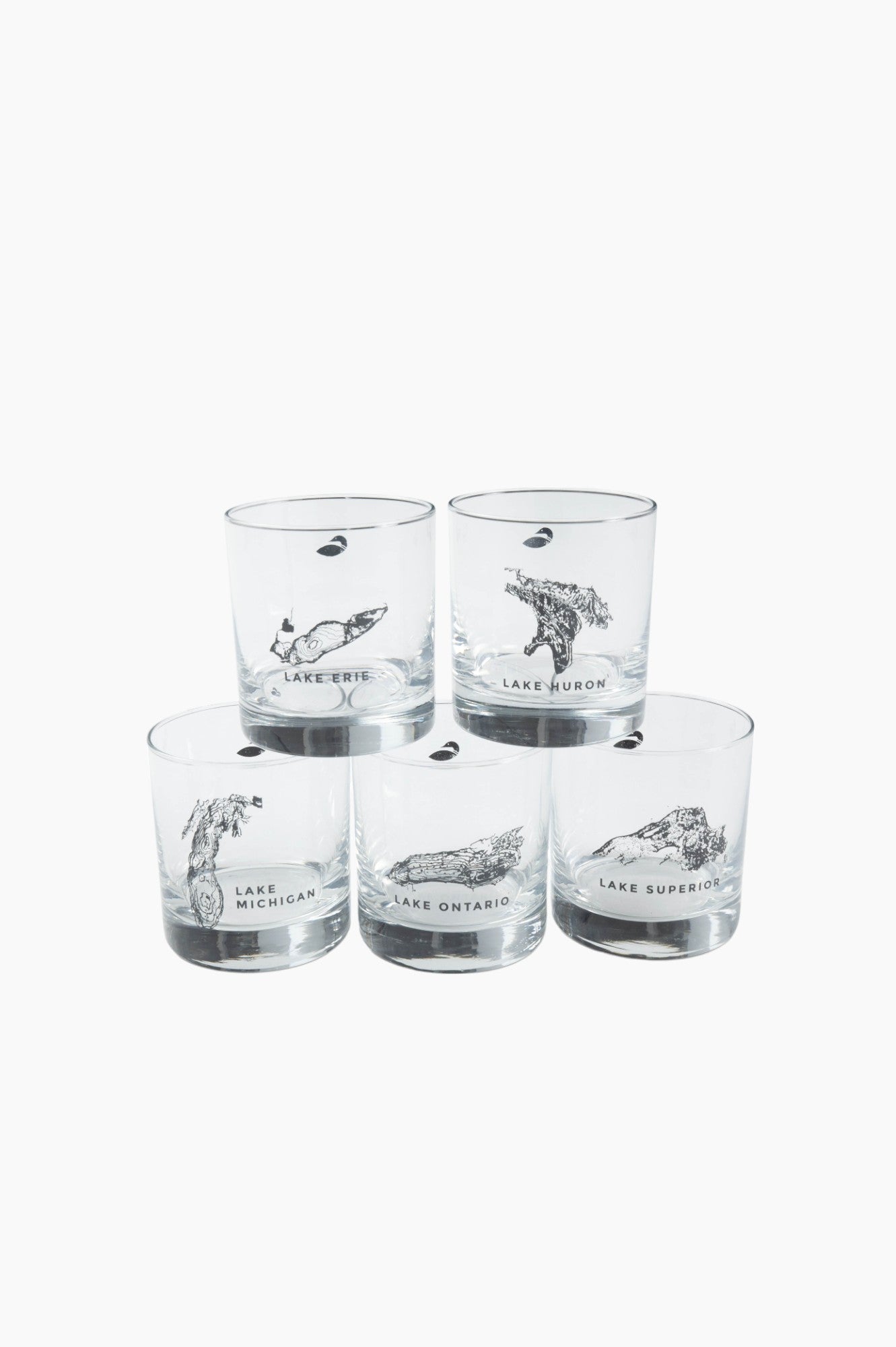 Clear drinking glasses stack on top of one another, each with a printed great lake on it.