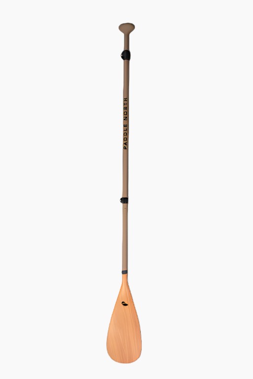 Paddle board paddle with wood blade and matte tan shaft.