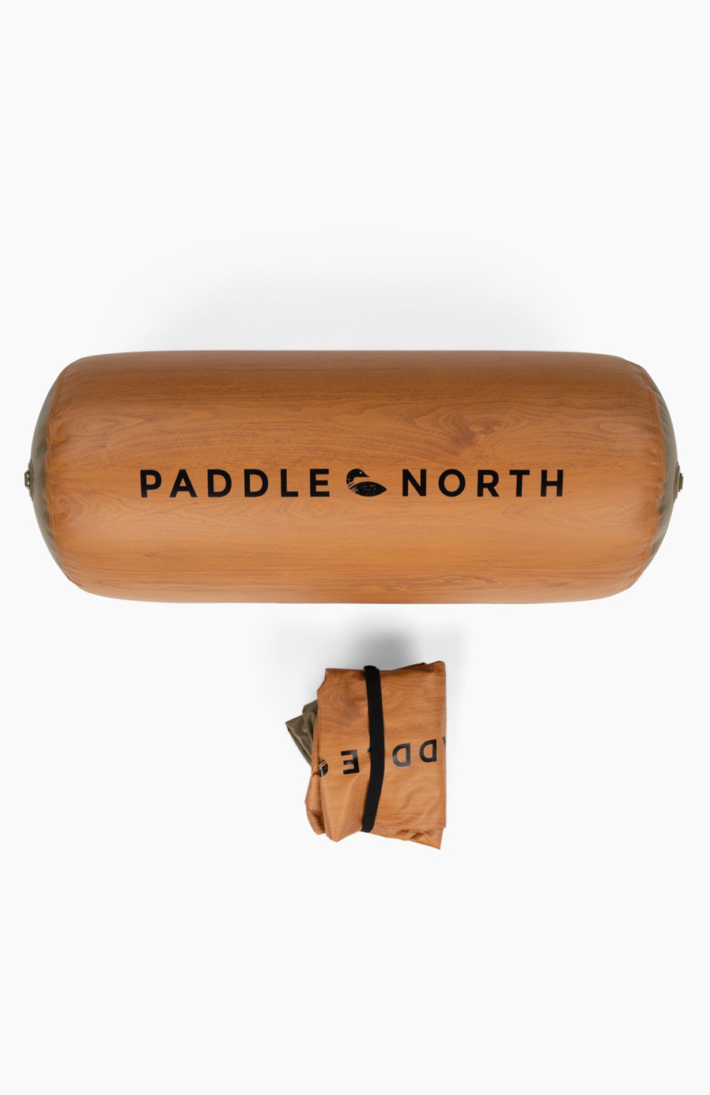 Dock accessories: Brown inflatable log with paddle north logo on it next to a deflated log rolled up.