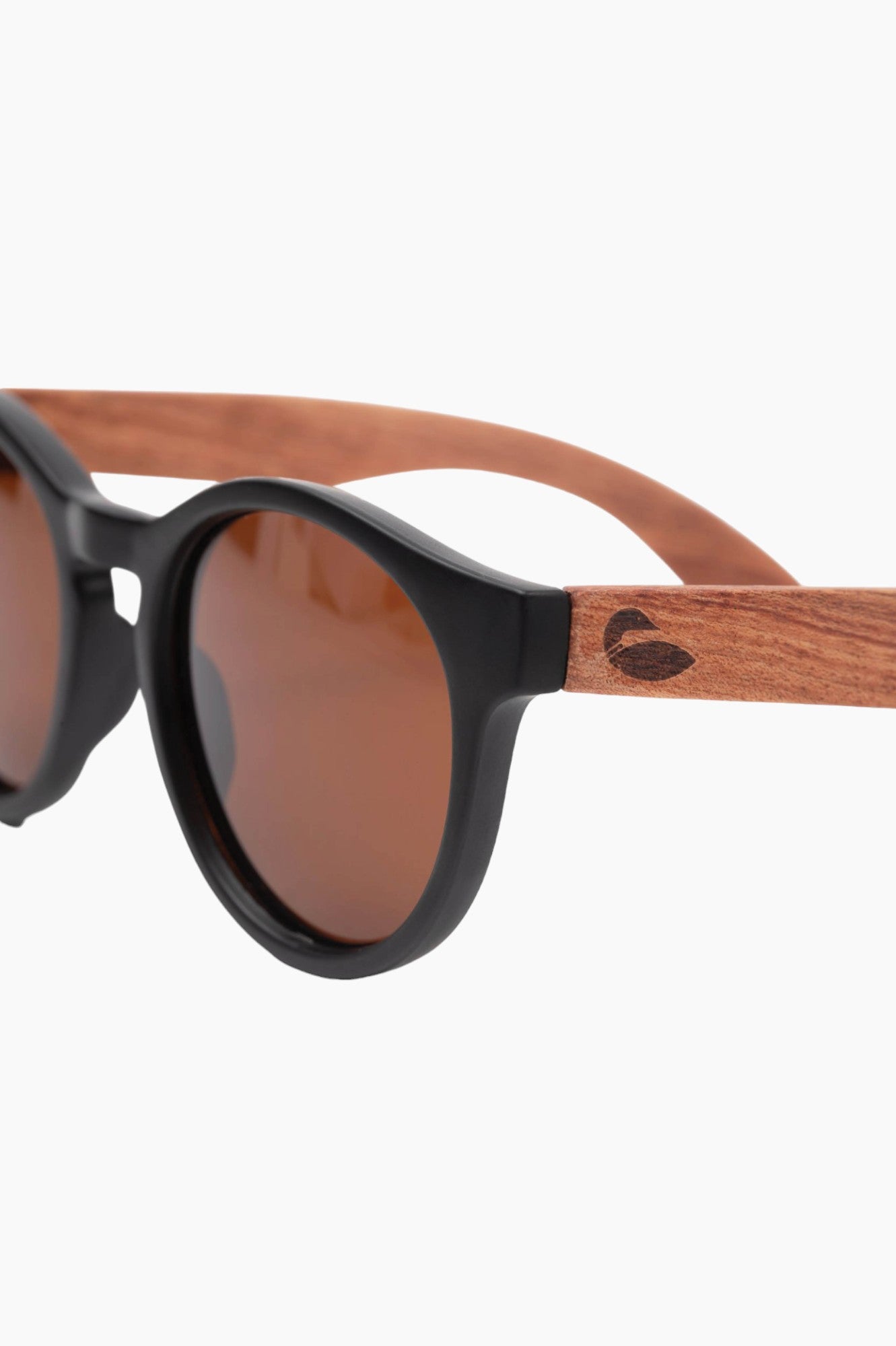 Matte black round sunglass frames with wood temple piece with a loon on them.
