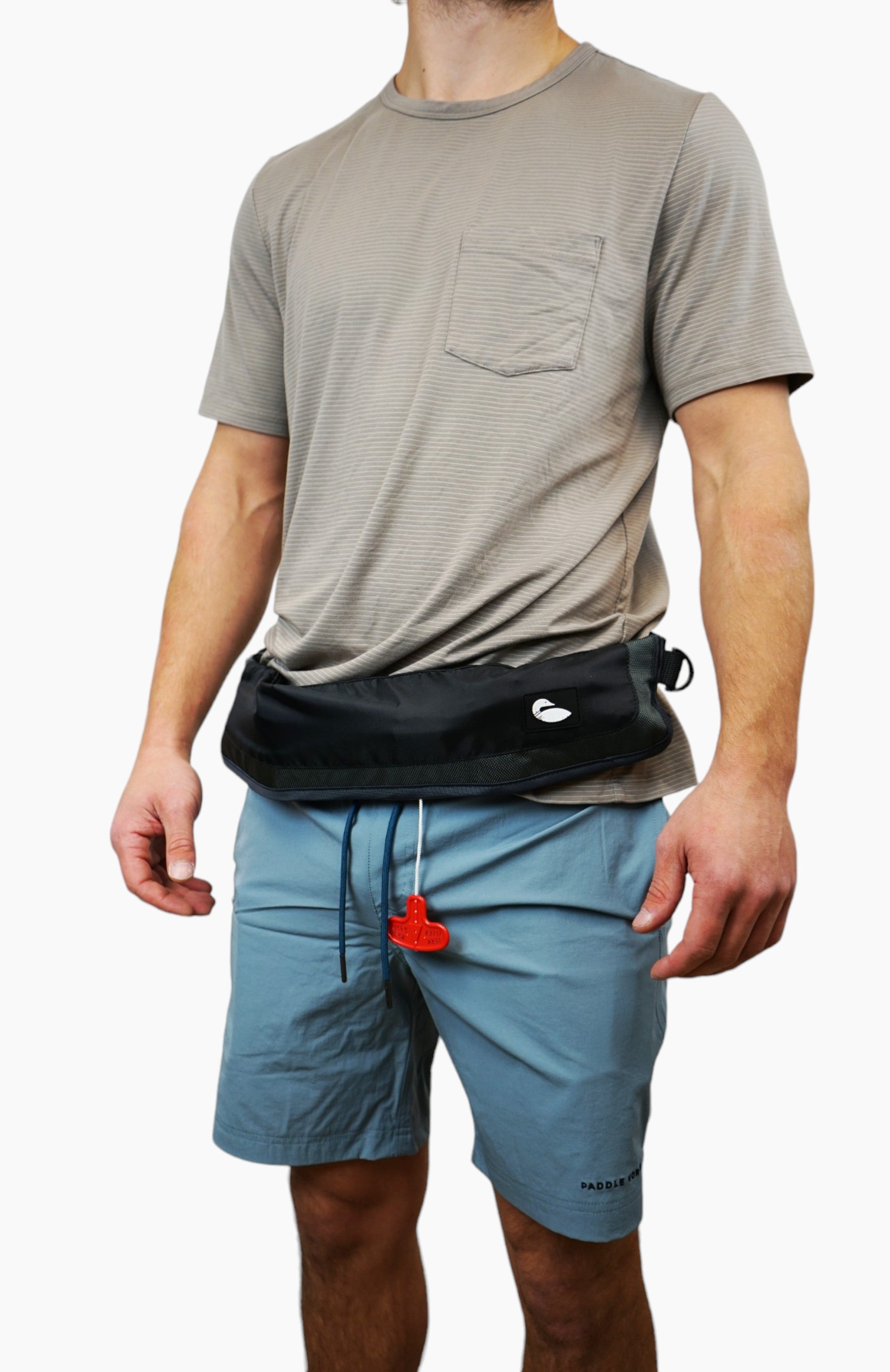 Water accessories: man wearing an inflatable life jacket stored in a black bag worn like a belt.