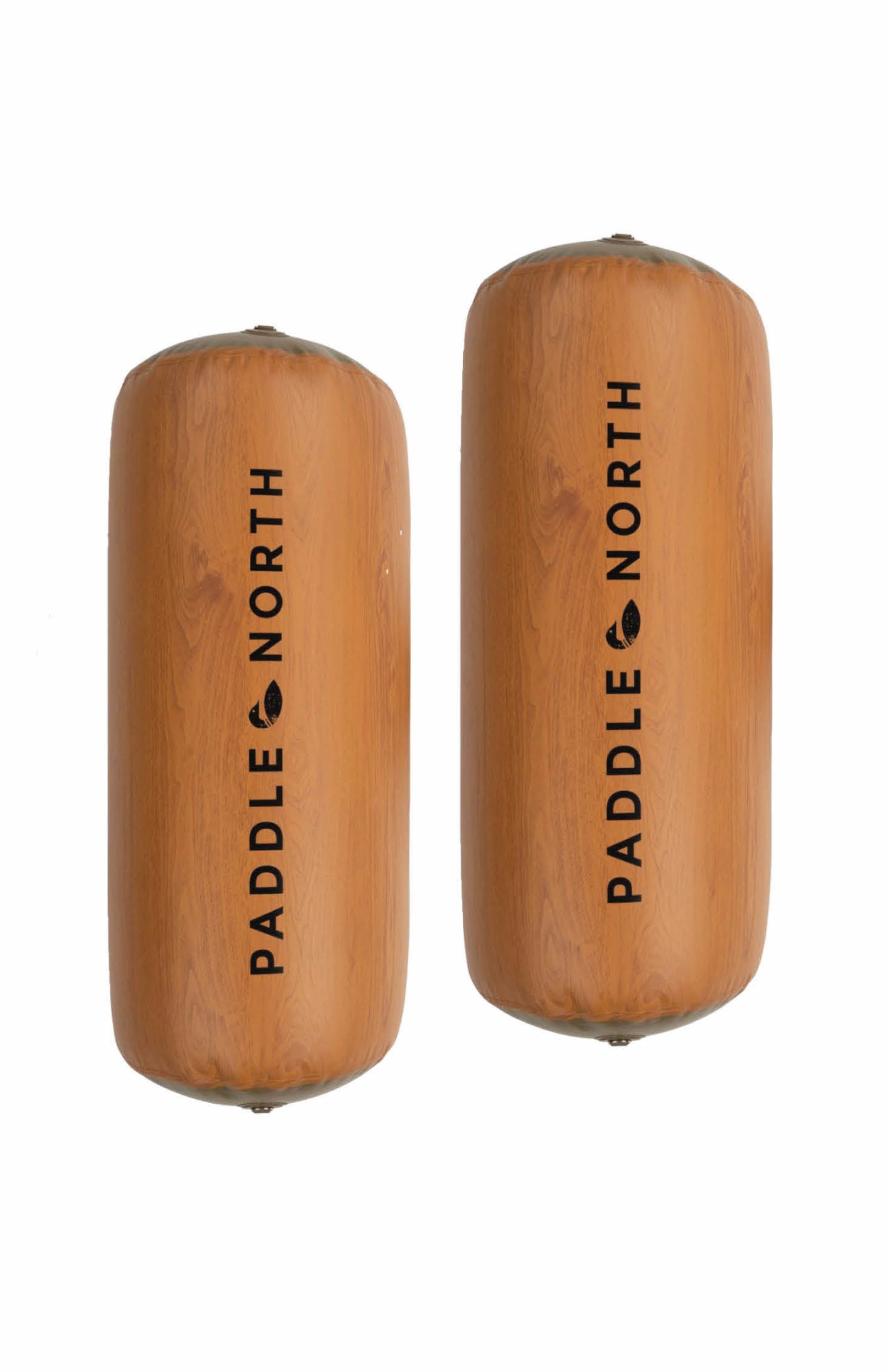 Dock accessories: two brown inflatable logs next to each other with paddle north logos on them.
