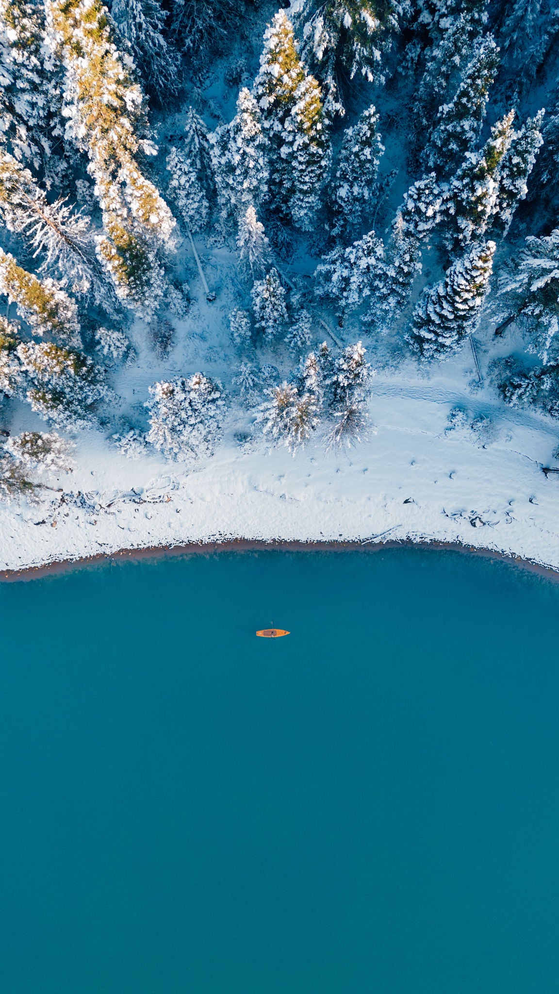 Drone view of Portager inflatable paddle board on blue lake in Utah during the winter